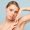 Beautiful Caucasian tender feminine half naked topless young woman 20s with nude make up look camera isolated on plain pastel blue color background. Skin care healthcare cosmetic procedures concept